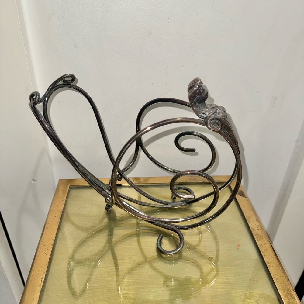 Art Nouveau Elkington silver-plated wine bottle holder with a stylized figure